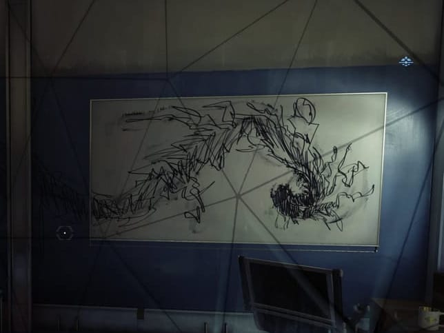 A whiteboard with black monstrous shape scribbled on frantically 